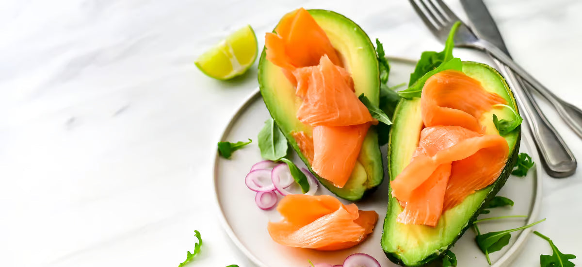 A plate of healthy food featuring avocado, fate, zits and onions