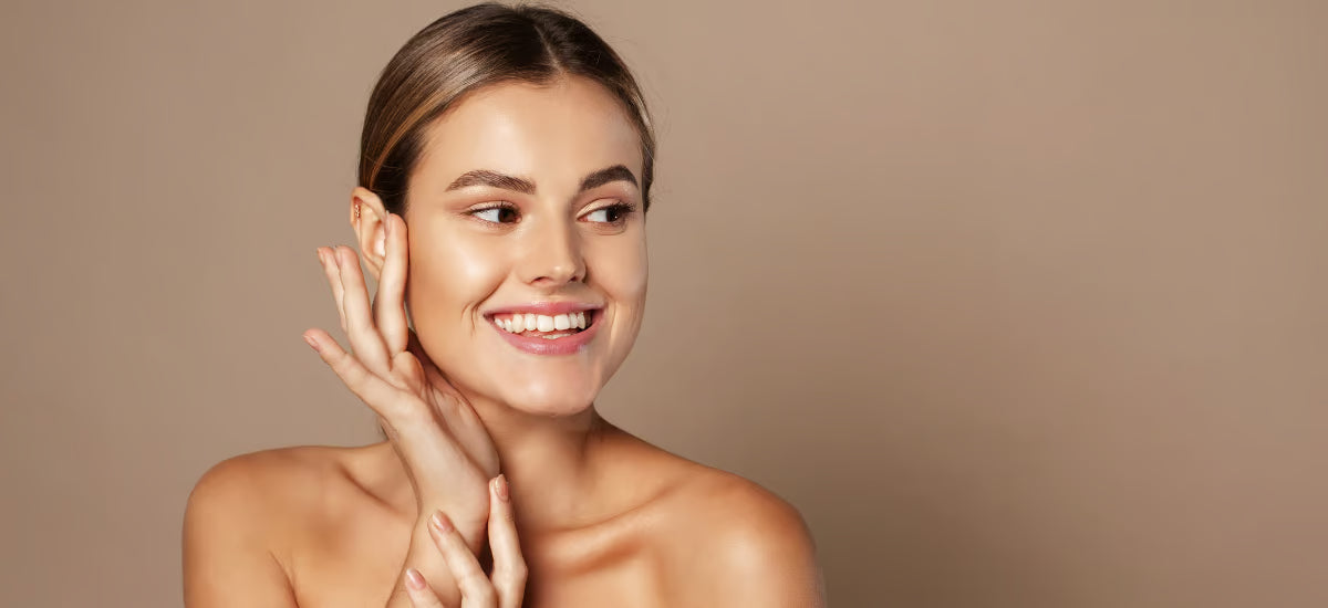 Smiling woman with radiant, healthy skin showing the glass skin effect after Primabiotic Collagen supplementation