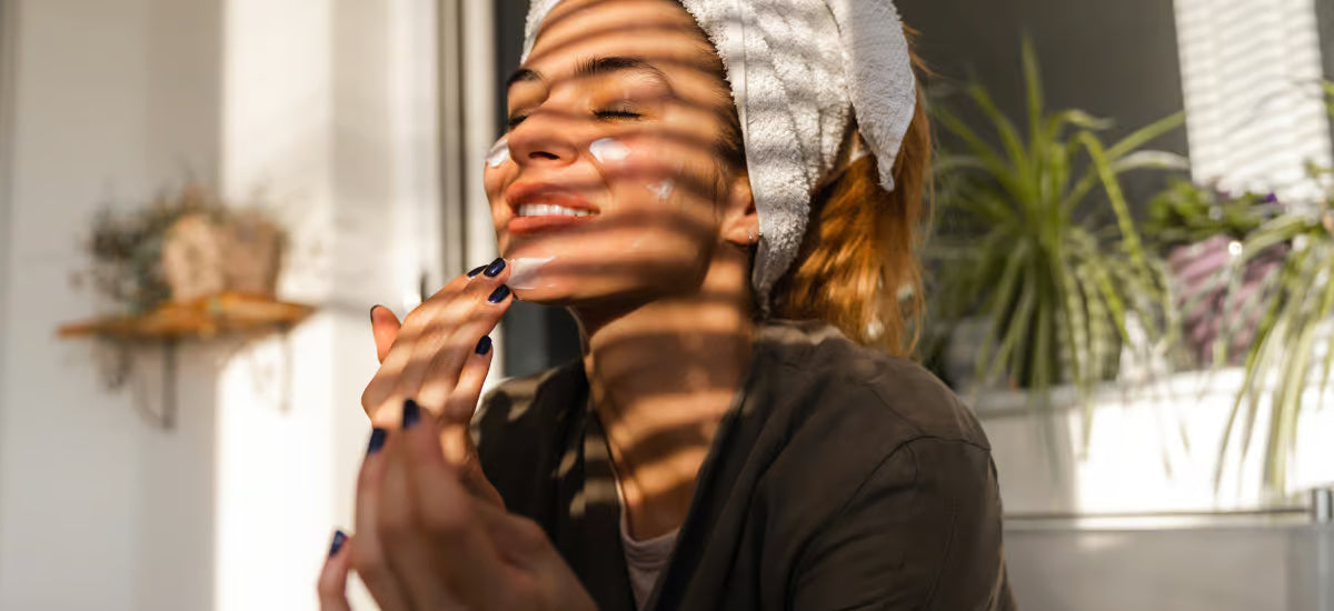 A woman taking care of her skin by applying cream