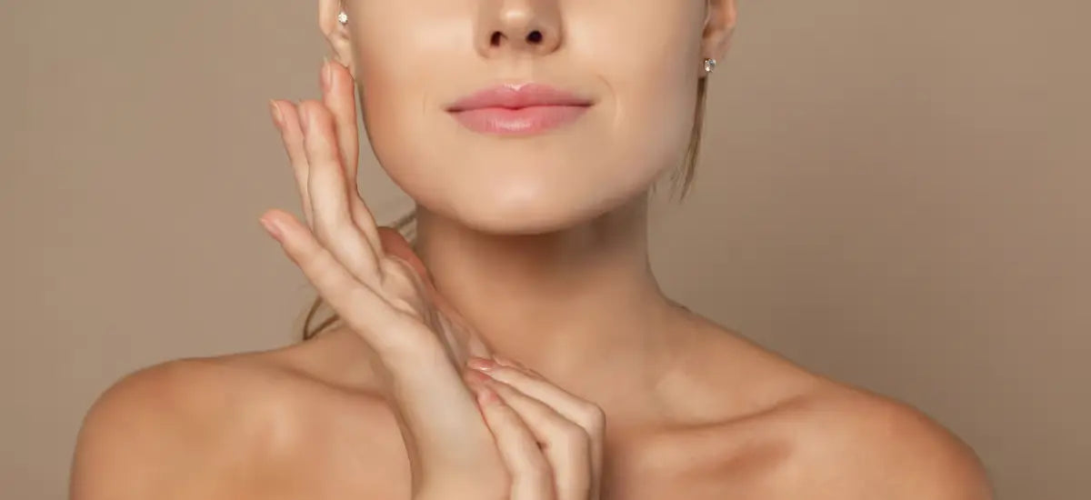 woman with smooth and radiant skin touches her face