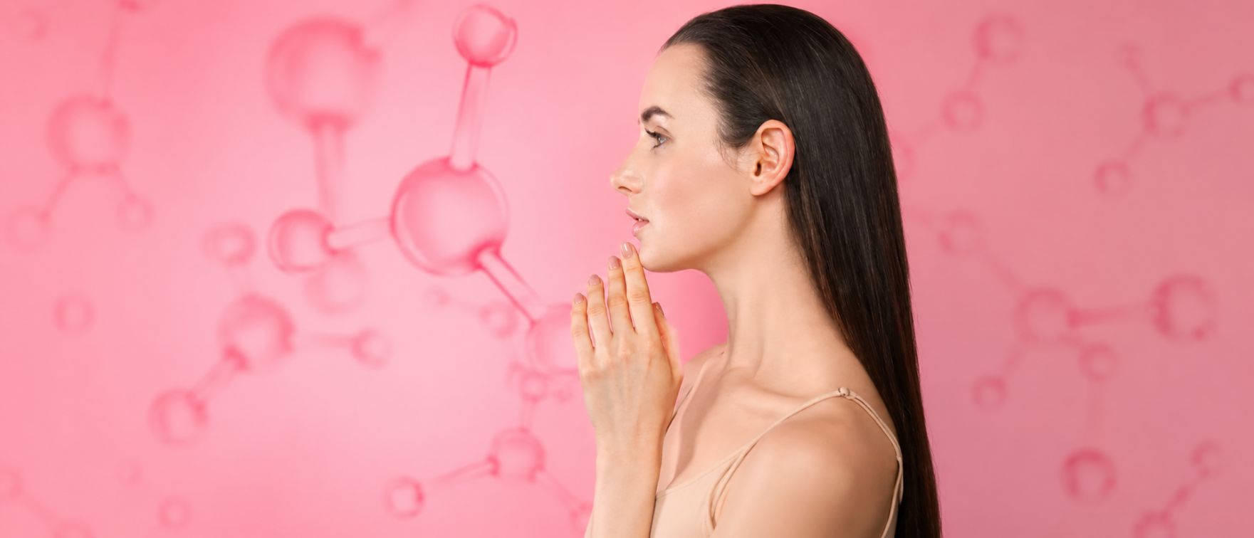 Young dark-haired woman showing her radiant, wrinkle-free skin after Primabiotic collagen supplementation, against a background of collagen peptides