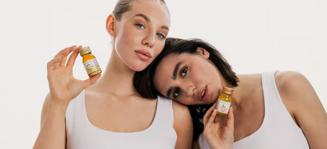 two women leaning against each other and holding collagen primabiotic and hyaluronic acid in their hands