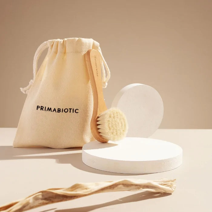 Primabiotic face massage brush with natural bristles and eco cotton pouch, perfect for daily facial care and healthy glow.