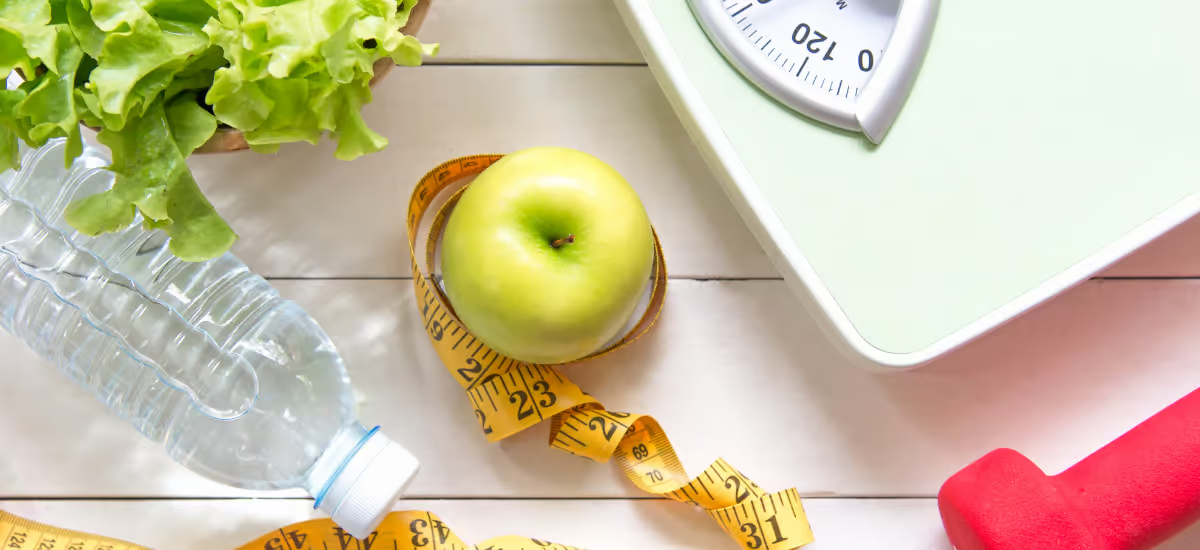 water, apple and scale placed on the table